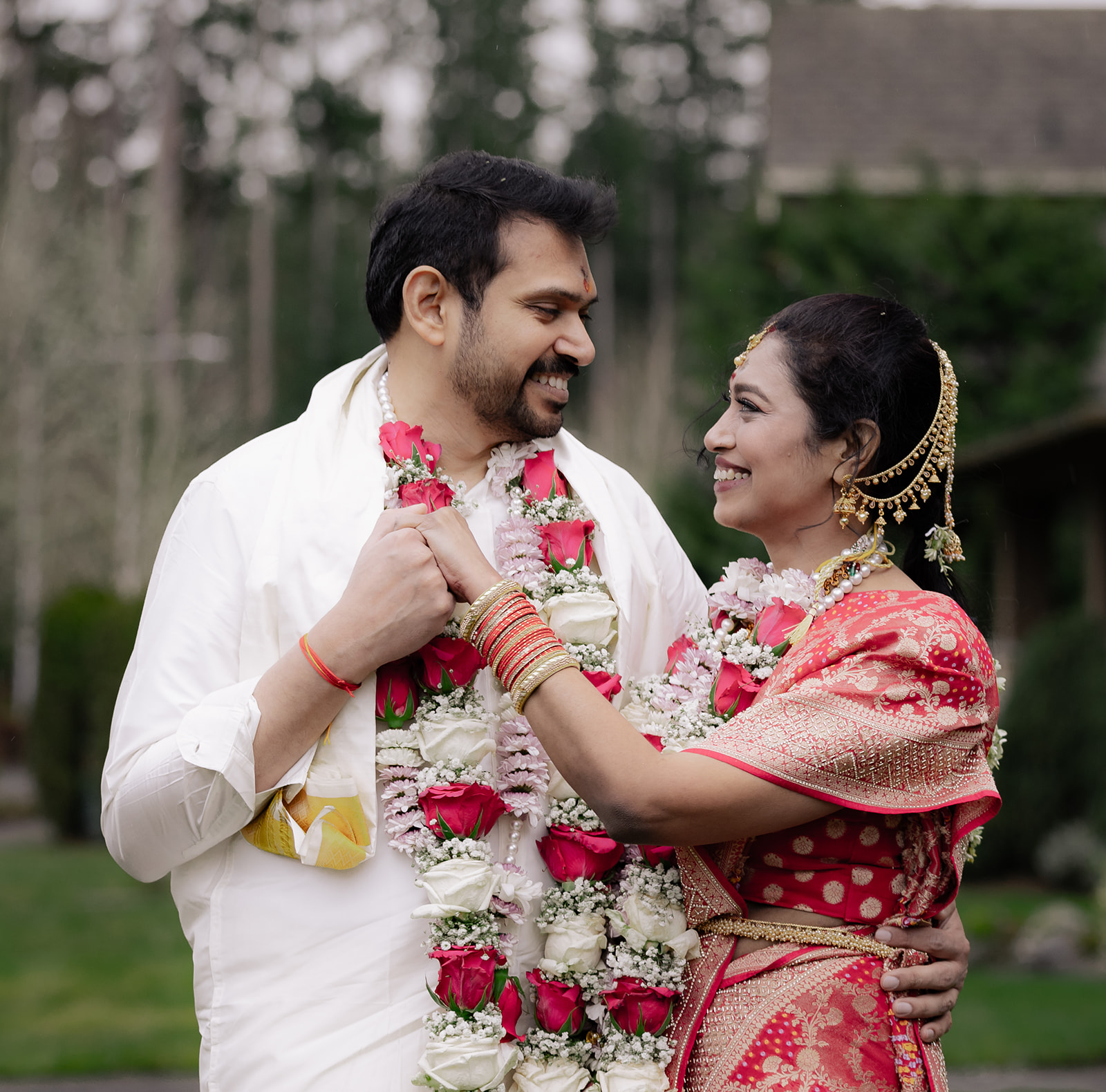 A wedding couple sharing a tender look in a garden