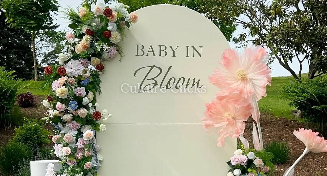 Baby in Bloom arch with cascading florals and oversized paper flowers