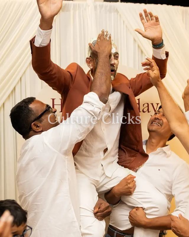 Friends lift the guest of honor in celebration at a birthday party