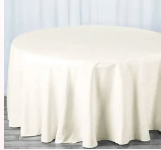 Round table with cream linen tablecloth