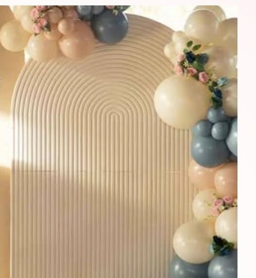Cream ribbed arch backdrop with balloon and floral garland