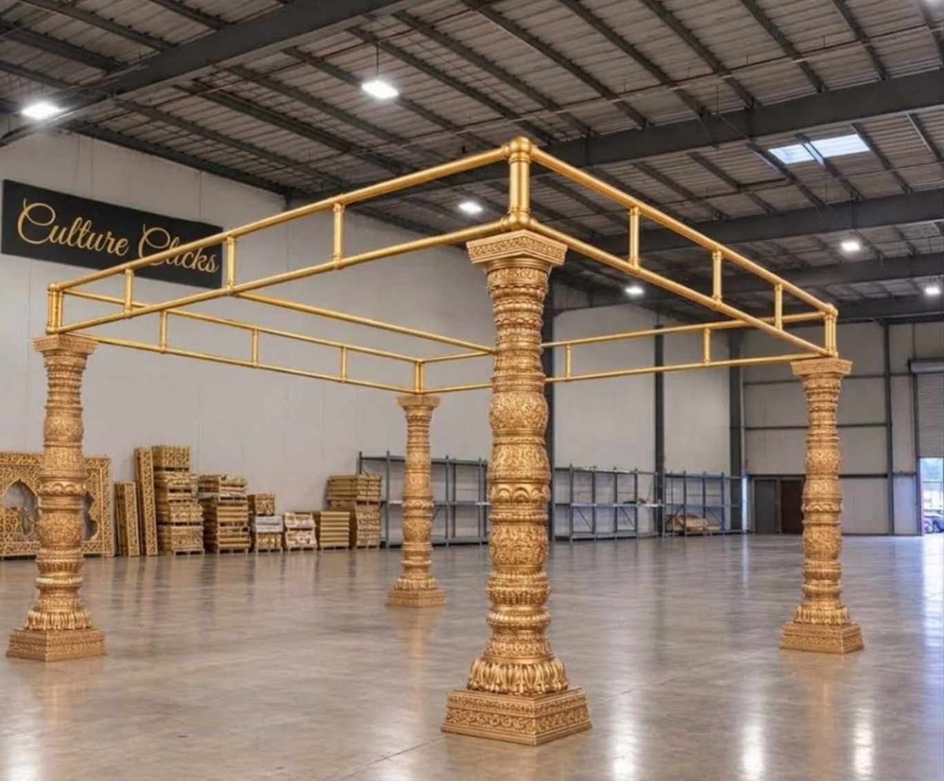 Gold mandap with four carved gold pillars and a gold frame